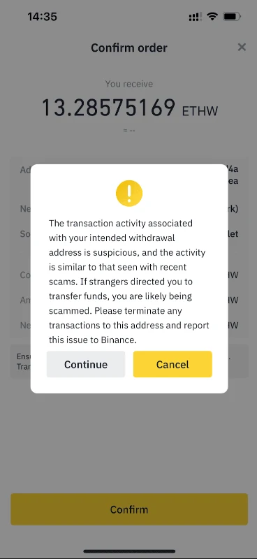 幣安 App 確認提領畫面上的官方示範彈窗,警告該地址交易活動可疑且與近期詐騙相似,下方有 Continue 與 Cancel 兩顆按鈕